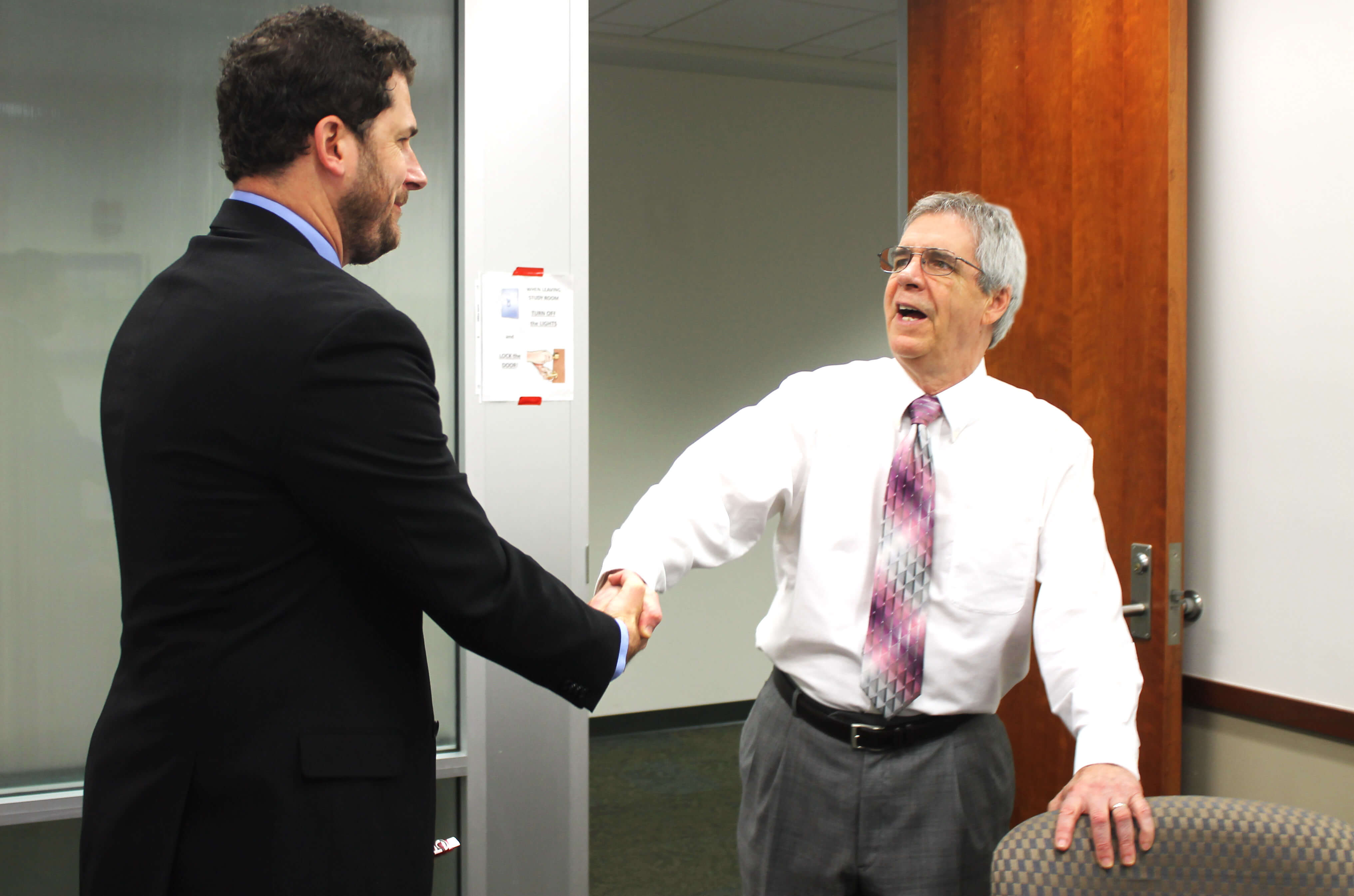 Handshake in board room