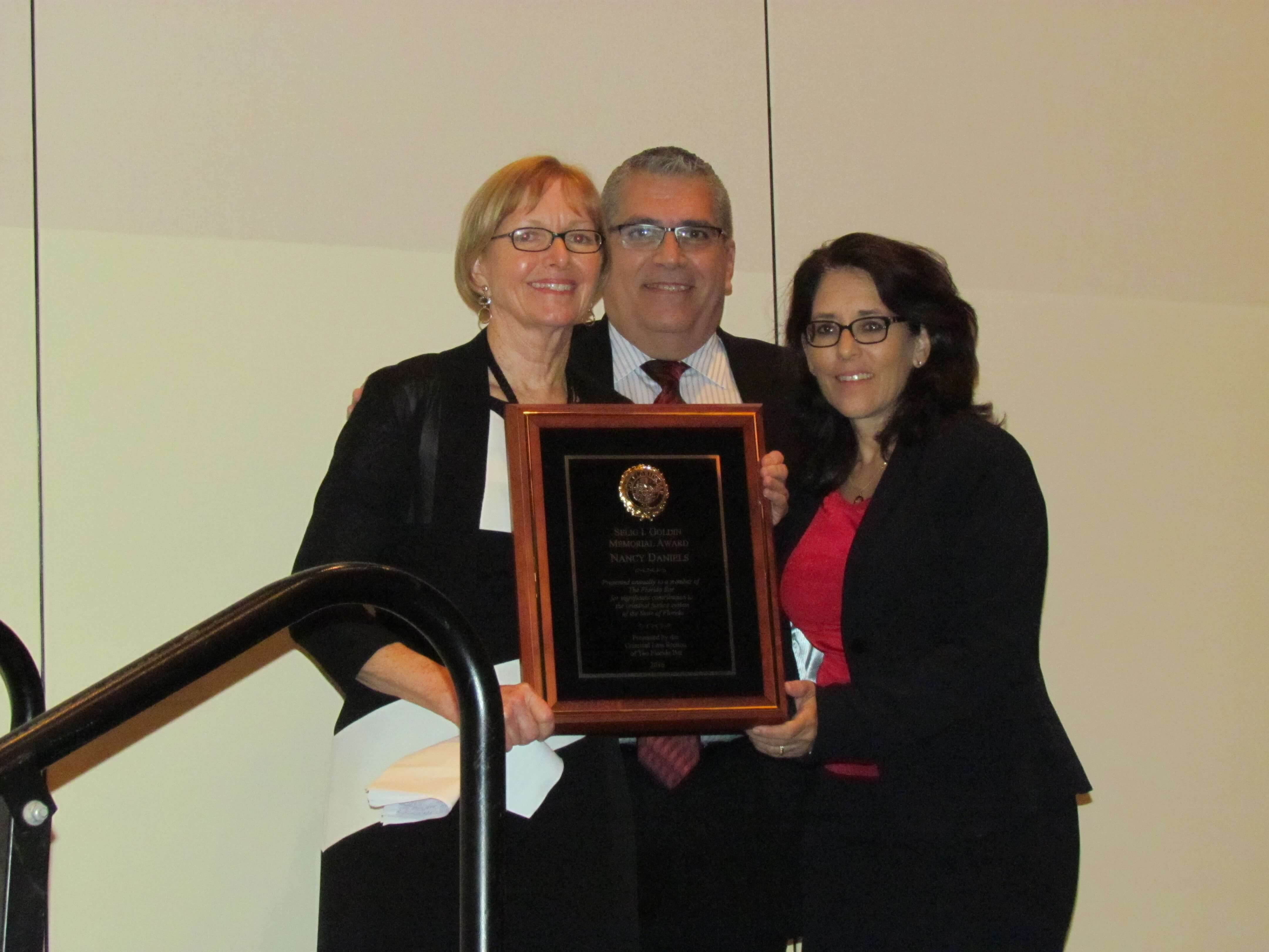 Nancy Daniels with Carlos Martinez & Judge Angelica Zayas holding award