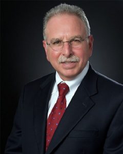Man wearing business attire and glasses