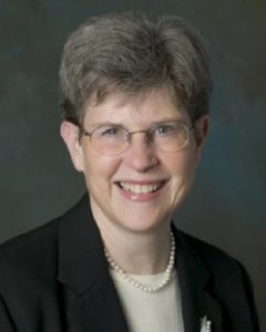 Image of a smiling woman wearing glasses