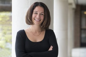 Image of a smiling woman with folded arms