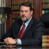 a man with facial hair in a library