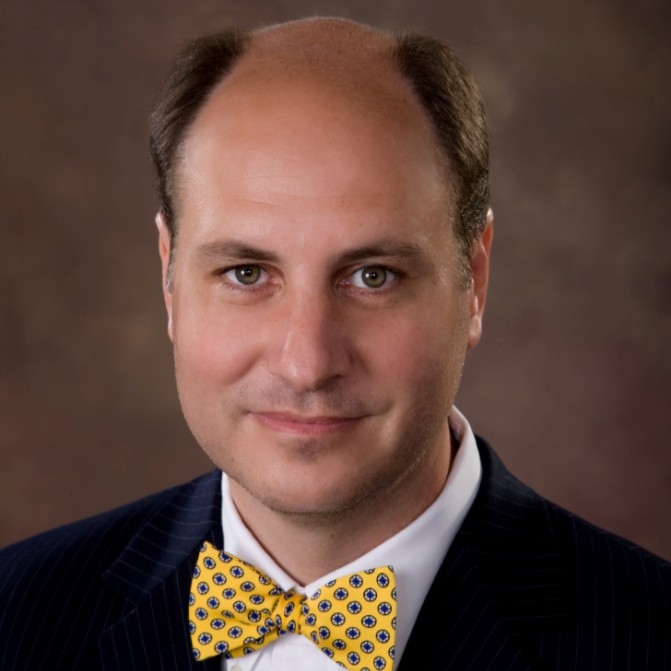a man wearing a yellow bow tie