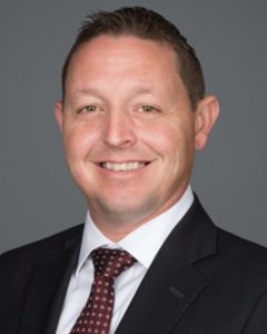 a man wearing a dark jacket and tie