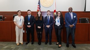 a group of people in front of a flag posing for the camera