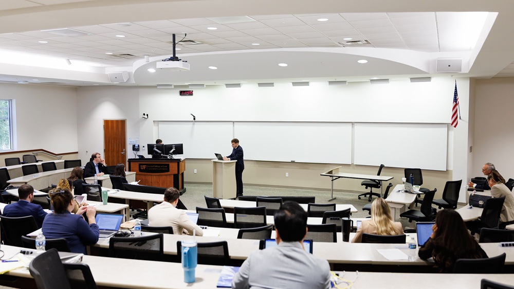 a person standing at a podium addressing an audience