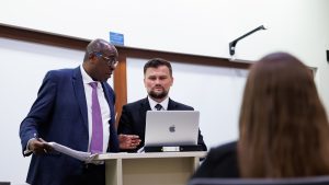 two persons standing at a podium
